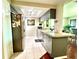 Kitchen featuring sleek gray cabinetry, stainless steel refrigerator, and tile flooring at 3447 Paloma Dr, Holiday, FL 34690