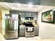 Kitchen featuring gray cabinets and stainless steel appliances at 3447 Paloma Dr, Holiday, FL 34690