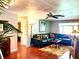 Inviting living room features a comfortable, modern sectional sofa and striking, colorful area rug at 3447 Paloma Dr, Holiday, FL 34690