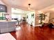 Living room with hardwood floors, a dining area, and an open floor plan at 3447 Paloma Dr, Holiday, FL 34690