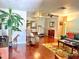 Comfortable living room with hardwood floors, a ceiling fan, and a variety of seating options at 3447 Paloma Dr, Holiday, FL 34690