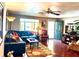 Relaxing living room showcasing hardwood floors, a ceiling fan, and a comfortable sectional sofa at 3447 Paloma Dr, Holiday, FL 34690