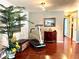 Hardwood floor in a bright living room featuring a treadmill and interior decor at 3447 Paloma Dr, Holiday, FL 34690