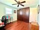 Multi-purpose room with a murphy bed, desk area, and hardwood floors and a ceiling fan at 3447 Paloma Dr, Holiday, FL 34690