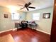 Functional office space featuring hardwood floors, desk area, and natural light from the windows at 3447 Paloma Dr, Holiday, FL 34690