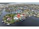 Beautiful aerial shot of a home with boat lift, a private pool and waterfront access to a canal community at 3701 Corsair Ct, New Port Richey, FL 34652