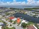 This aerial shows a waterfront home with a private dock and lift, and easy access to waterways at 3701 Corsair Ct, New Port Richey, FL 34652