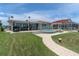 Backyard with a swimming pool, patio, lush green grass, and an outdoor grill at 3701 Corsair Ct, New Port Richey, FL 34652