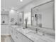 Bright bathroom boasts a double sink vanity with stunning marble countertops and modern fixtures at 3701 Corsair Ct, New Port Richey, FL 34652