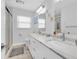 Bathroom showcases double sinks with marble countertops and a glass-enclosed shower at 3701 Corsair Ct, New Port Richey, FL 34652