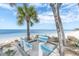 Beautiful beachside seating with palm trees and ocean views create a serene coastal escape at 3701 Corsair Ct, New Port Richey, FL 34652