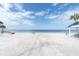 Beach access path on beautiful beach with clear skies and beach shelter at 3701 Corsair Ct, New Port Richey, FL 34652