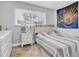 Comfortable bedroom features a serene atmosphere and natural light from the window at 3701 Corsair Ct, New Port Richey, FL 34652