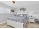 Comfortable bedroom with neutral tones, a decorative headboard, and stylish side tables at 3701 Corsair Ct, New Port Richey, FL 34652