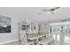 Dining room featuring wood table, white chairs, bench and a view of the outdoor deck at 3701 Corsair Ct, New Port Richey, FL 34652