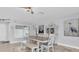 Dining area with a light wood table and a combination of chairs and bench seating at 3701 Corsair Ct, New Port Richey, FL 34652