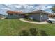 Charming home exterior featuring a well-manicured lawn, paved walkway, and attached garage with a vehicle at 3701 Corsair Ct, New Port Richey, FL 34652