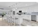 Bright kitchen featuring white cabinetry, stainless steel appliances, and a spacious island with seating at 3701 Corsair Ct, New Port Richey, FL 34652
