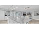Spacious kitchen with a large island and white countertops, with seating and adjacent dining area at 3701 Corsair Ct, New Port Richey, FL 34652