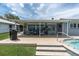 Covered patio with grill and outdoor seating, perfect for entertaining and enjoying waterfront views at 3701 Corsair Ct, New Port Richey, FL 34652