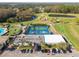 An aerial view of community with tennis courts, a pond, golf course, and clubhouse with ample parking at 3745 Teeside Dr # 3745, New Port Richey, FL 34655