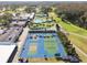 An aerial shot showcasing tennis courts, a swimming pool, and a clubhouse in a vibrant neighborhood at 3745 Teeside Dr # 3745, New Port Richey, FL 34655