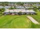 Aerial view of condos overlooking a picturesque golf course and sand trap at 3745 Teeside Dr # 3745, New Port Richey, FL 34655