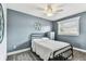 Inviting bedroom featuring textured wall, ceiling fan and window with blinds at 3745 Teeside Dr # 3745, New Port Richey, FL 34655