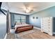 Cozy bedroom featuring a decorative ceiling fan and a white dresser at 3745 Teeside Dr # 3745, New Port Richey, FL 34655
