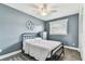 Cozy bedroom featuring stylish metal bed frame, ceiling fan and window at 3745 Teeside Dr # 3745, New Port Richey, FL 34655