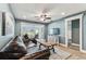 Inviting living room featuring wood-look tile flooring, a leather sofa set, and access to the lanai at 3745 Teeside Dr # 3745, New Port Richey, FL 34655