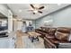 Comfortable living room with a leather sofa, a ceiling fan, and a view of the kitchen at 3745 Teeside Dr # 3745, New Port Richey, FL 34655