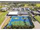 Community tennis courts with parking and golf cart staging, all in a lush, green neighborhood at 3745 Teeside Dr # 3745, New Port Richey, FL 34655