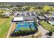 Aerial view of tennis courts, parking and clubhouse within a vibrant residential community at 3745 Teeside Dr # 3745, New Port Richey, FL 34655