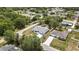 Aerial view showcasing a well-maintained home with a pristine driveway, surrounded by verdant landscaping at 4360 Talco Ave, Spring Hill, FL 34609