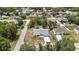 Aerial view of a home surrounded by lush landscaping with a long driveway and a well-maintained lawn at 4360 Talco Ave, Spring Hill, FL 34609