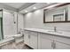 Bathroom features quartz countertop vanity, framed mirror, and glass shower stall at 4360 Talco Ave, Spring Hill, FL 34609