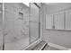 Elegant bathroom features a glass-enclosed shower with marble tile and built-in storage at 4360 Talco Ave, Spring Hill, FL 34609