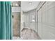 Bathroom with tiled shower, modern fixtures, and closet space at 4360 Talco Ave, Spring Hill, FL 34609