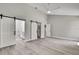 Bedroom features barn door to the bathroom, closet and modern wood floors and ceiling fan at 4360 Talco Ave, Spring Hill, FL 34609
