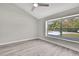 A bright room with high ceilings, light gray walls, light wood-look floors, and a large window at 4360 Talco Ave, Spring Hill, FL 34609