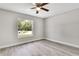 A bright room with high ceilings, light gray walls, light wood-look floors, and a large window at 4360 Talco Ave, Spring Hill, FL 34609