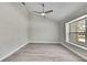 A bright room with high ceilings, light gray walls, light wood-look floors, and a large window at 4360 Talco Ave, Spring Hill, FL 34609