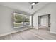 A bright room with high ceilings, light gray walls, light wood-look floors, and a large window at 4360 Talco Ave, Spring Hill, FL 34609