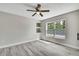 Bright bedroom featuring modern fan, recessed wall shelves, and ample natural light from a large window at 4360 Talco Ave, Spring Hill, FL 34609