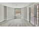 Bright dining area featuring light gray walls, wood floors, and a window with a view to the outside at 4360 Talco Ave, Spring Hill, FL 34609