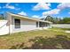 Home exterior features a screened porch and a fenced yard, offering privacy and outdoor living at 4360 Talco Ave, Spring Hill, FL 34609