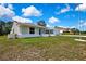 Single-story home featuring manicured landscaping, a front-facing garage, and a neatly maintained lawn at 4360 Talco Ave, Spring Hill, FL 34609