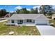 Charming single-story home with a well-maintained lawn, blue door, and attached two-car garage at 4360 Talco Ave, Spring Hill, FL 34609