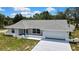 Beautiful exterior view of home showcasing architectural design, neutral colors, manicured lawn, and wide driveway at 4360 Talco Ave, Spring Hill, FL 34609